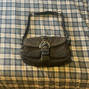 Black Coach purse with leather buckle and strap